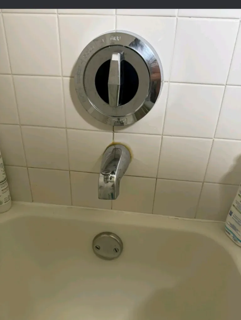 A bathtub faucet installed on the tub wall.