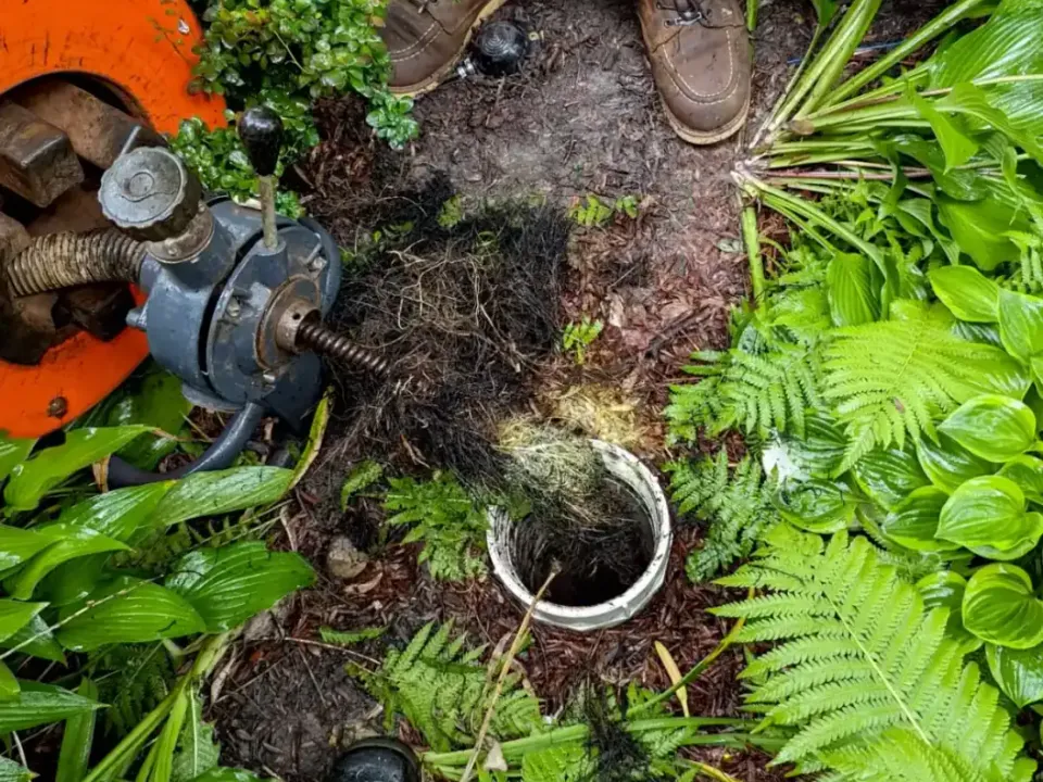 Power rodding equipment at an outdoor cleanout.