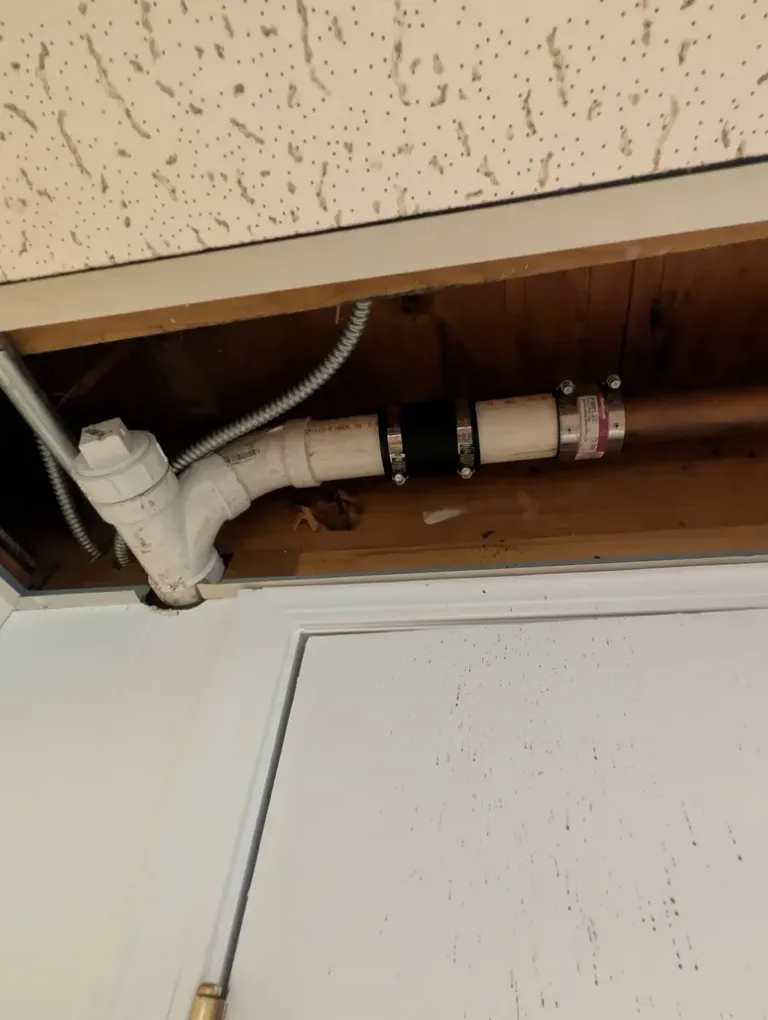PVC pipes exposed in a ceiling.