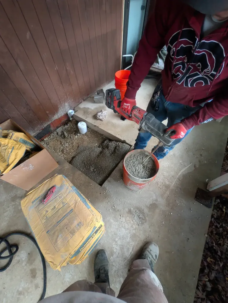 Workers mixing concrete at a repair site.