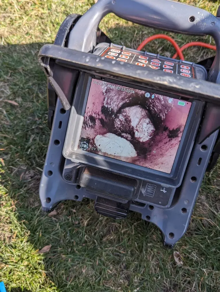 Portable sewer camera monitor outdoors.