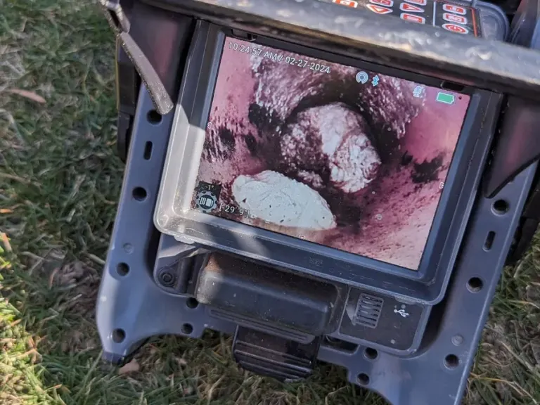 Portable sewer camera monitor outdoors.