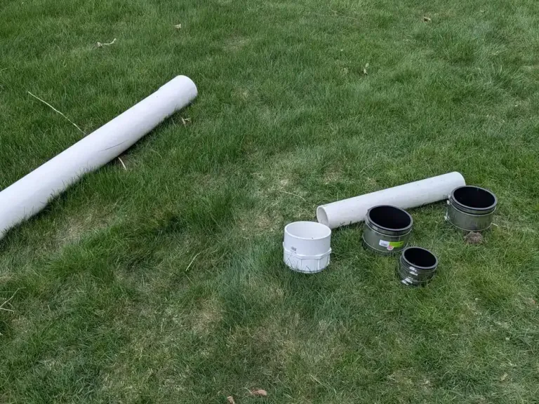 White replacement pipe sections on grass.