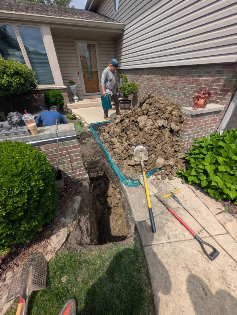 Open trench with blue pipe.