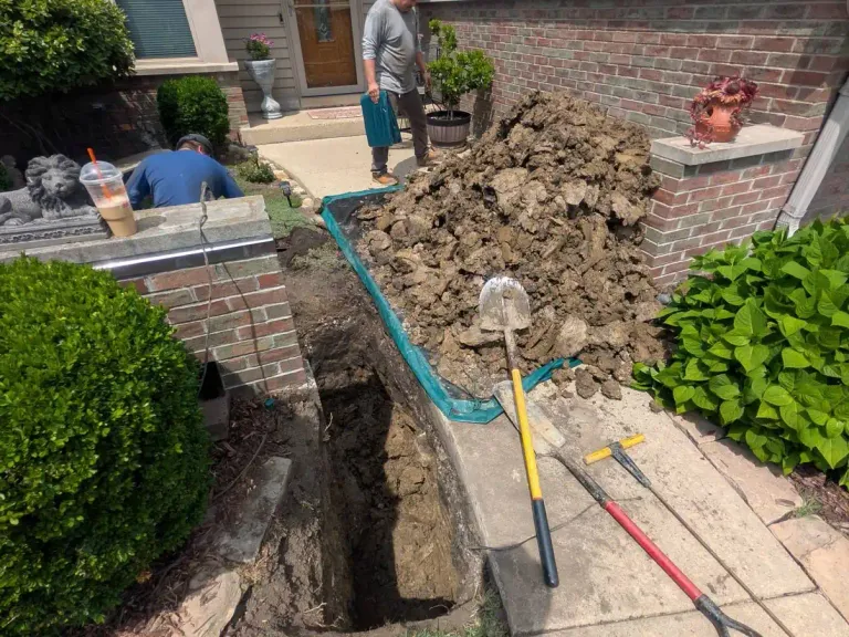 Open trench with blue pipe.