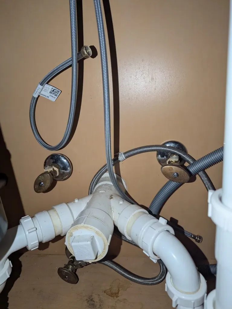 Under-sink drain and supply pipes.