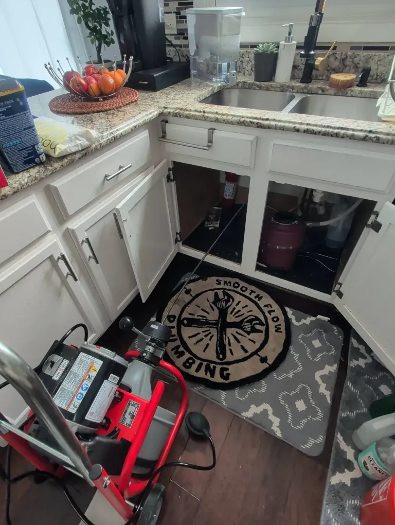 Under-sink work in progress with a Smooth Flow drop rug on the floor.