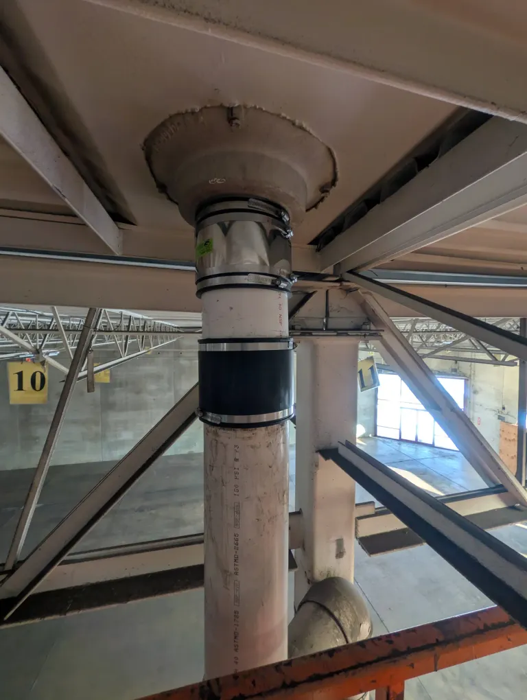 A sealed pipe in a warehouse ceiling.
